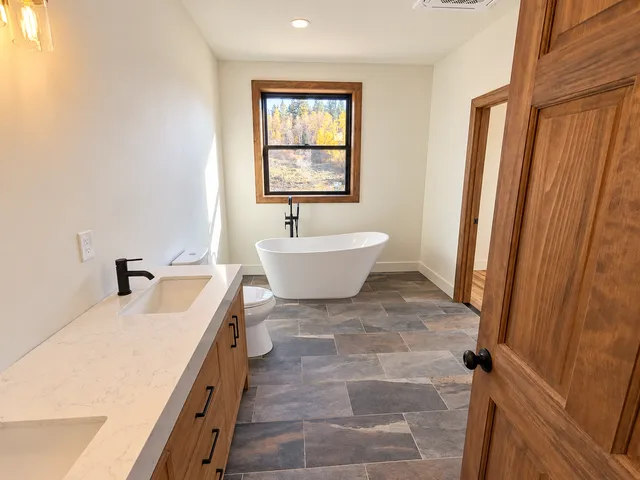 Primary bathroom with freestanding tub and vanity