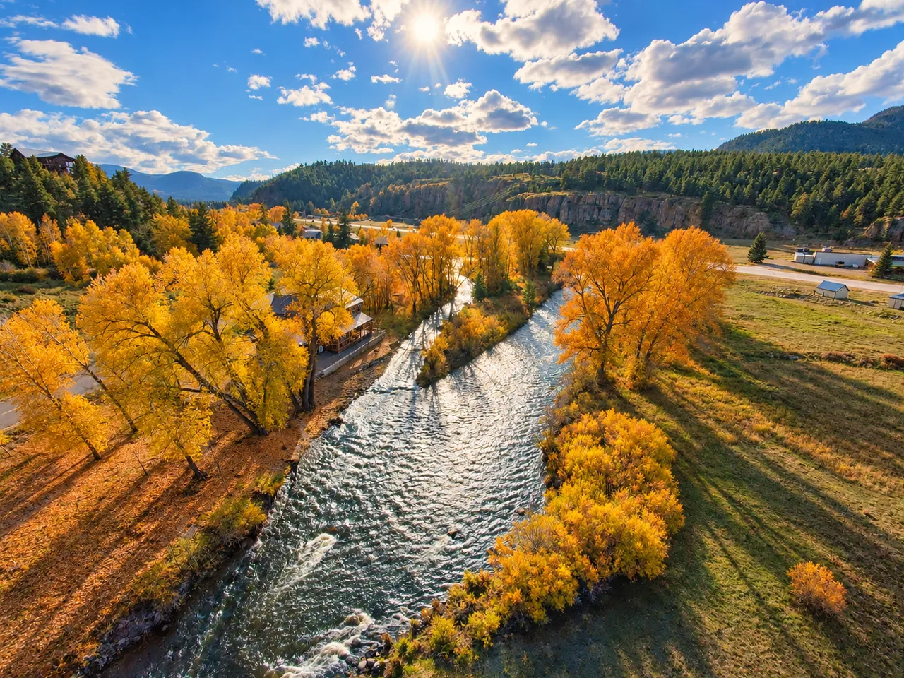 The river corridor and autumn trees in the home's mountain setting
