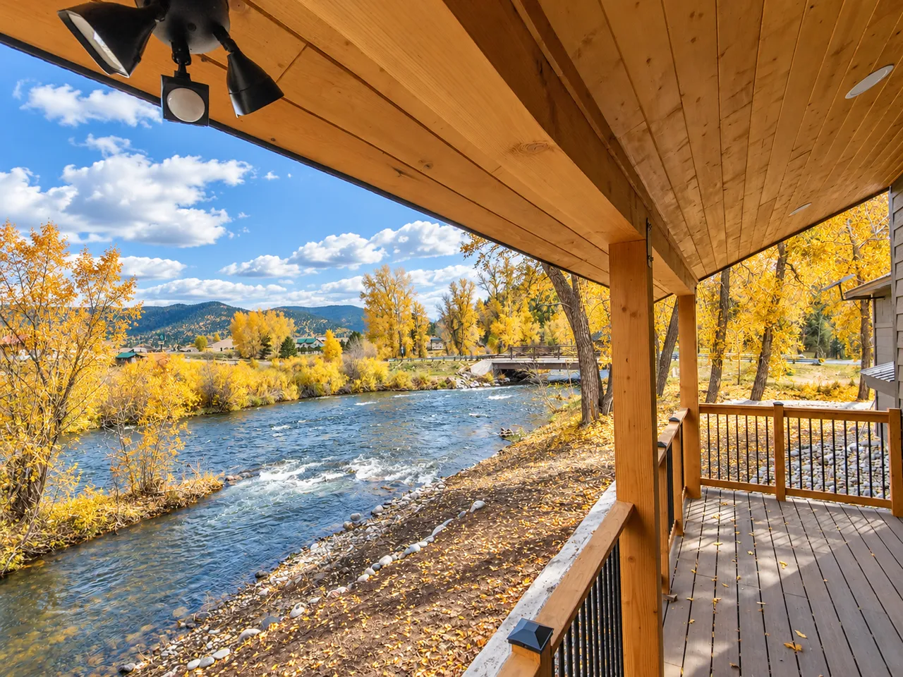 The covered porch with the river just beyond